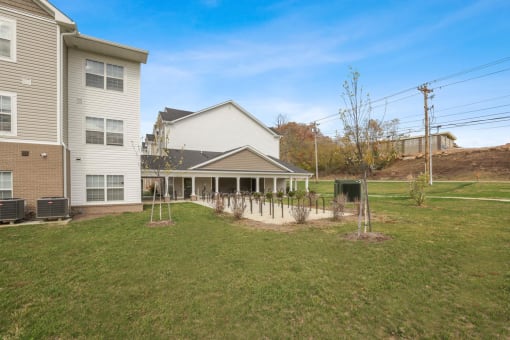 a backyard with a house and a yard with trees and grass