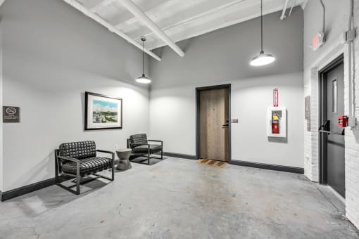 a waiting area with two chairs and a toilet
