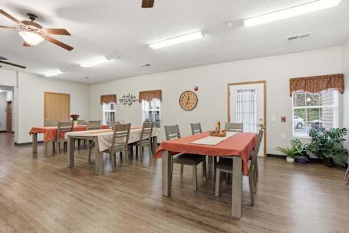 A dining room with a table set for six people.