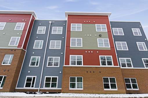 A multi-story apartment building with various colored exteriors.