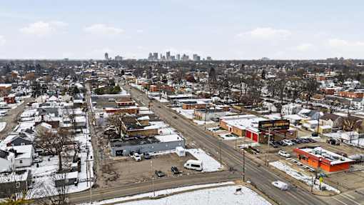 A cityscape with buildings, roads, and cars.