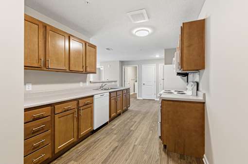 A kitchen with wooden cabinets and white appliances.