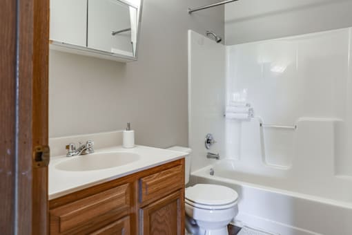 A white sink and toilet in a bathroom.