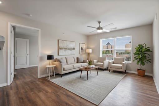 A living room with a couch, chairs, and a rug.