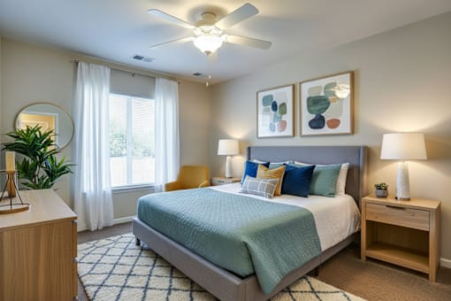 A bedroom with a bed, nightstand, and a plant.