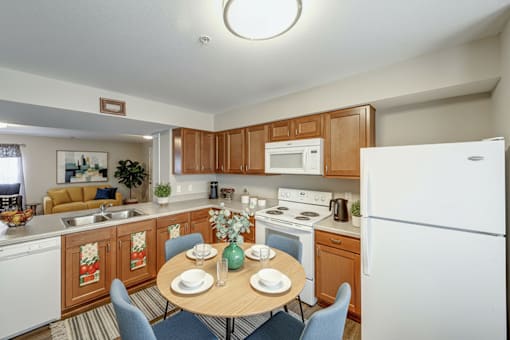 A kitchen with a table set for two.
