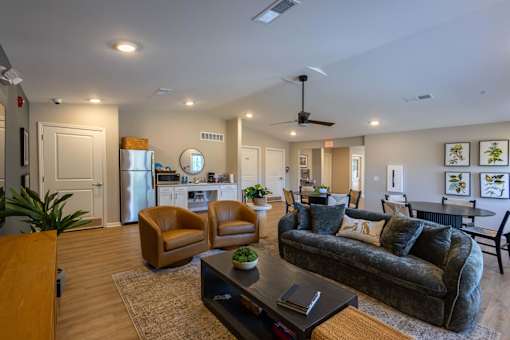 A living room with a couch, chairs, and a coffee table.