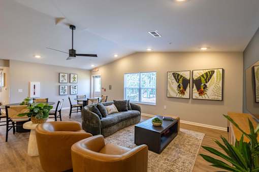 A living room with a couch, chairs, and a coffee table.