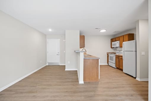 a kitchen with an island and a white refrigerator