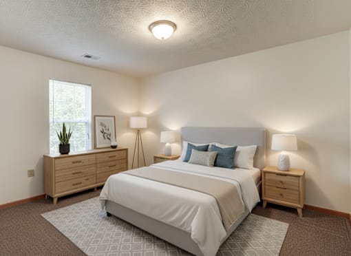 A bedroom with a bed, nightstands, and a window.