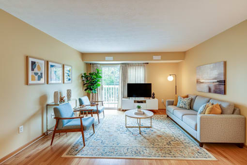 A living room with a couch, chairs, and a coffee table.