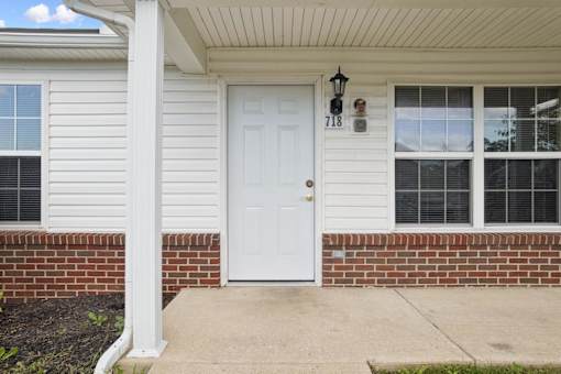 A white door with a black mailbox is on the front of a house.