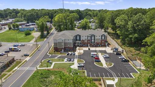 A parking lot with a building in the background.