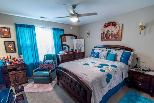 a bedroom with a bed and a ceiling fan