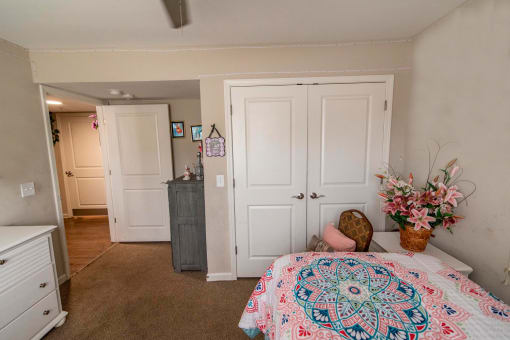 a bedroom with a bed and a dresser