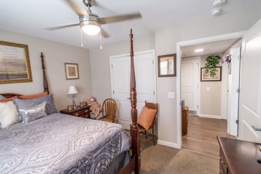 a bedroom with a bed and a ceiling fan