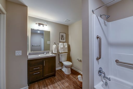 A bathroom with a toilet, sink, and shower.