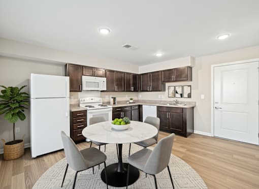 A modern kitchen with a white refrigerator, a white oven, and a white microwave.