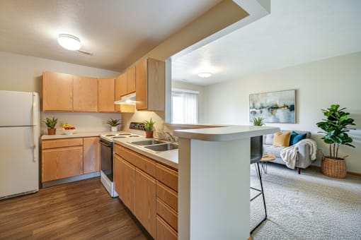A kitchen with wooden cabinets and a white refrigerator.