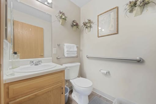 A white toilet sits next to a sink in a bathroom.