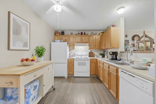 A kitchen with wooden cabinets and white appliances.