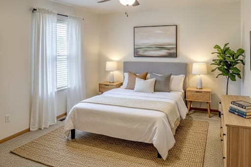 A bedroom with a large bed and a ceiling fan.