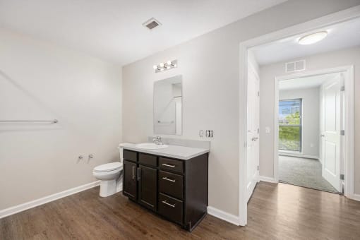 a white bathroom with a sink and a toilet