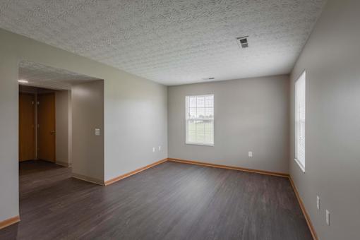 A room with a window and a door.