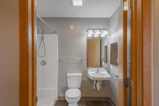 A white toilet and sink in a small bathroom.