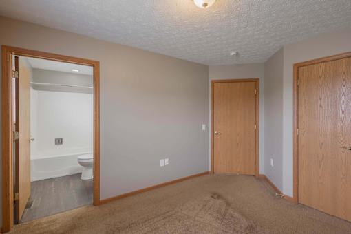A room with a toilet visible through the open door.