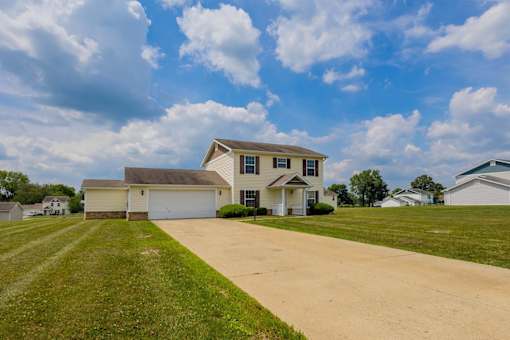 A large house with a driveway in front of it.