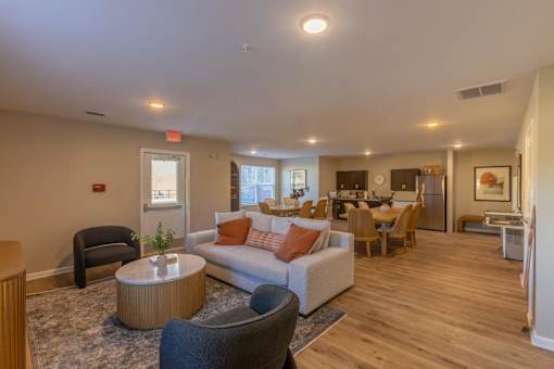 A living room with a grey couch and a brown coffee table.