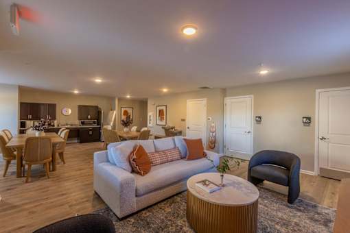 A living room with a couch, chairs, and a coffee table.