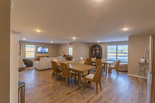 A dining room with a wooden table and chairs.