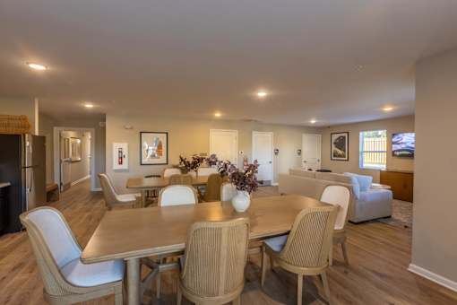 A dining room with a table and chairs.