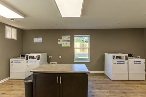 A room with a counter and a washing machine.