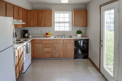 A kitchen with wooden cabinets and white appliances.