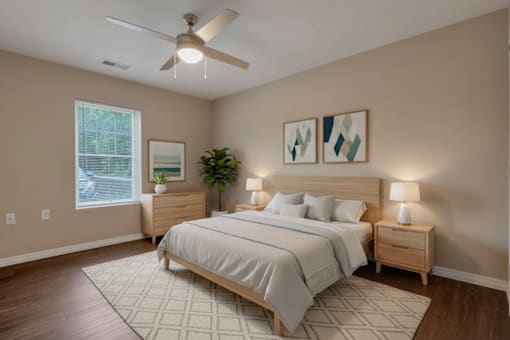 A bedroom with a large bed, a ceiling fan, and two nightstands.