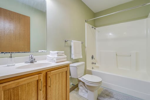 A bathroom with a toilet, sink, and bathtub.