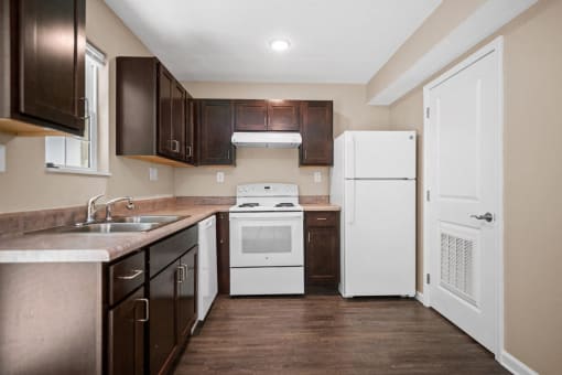 a kitchen with a stove refrigerator and sink