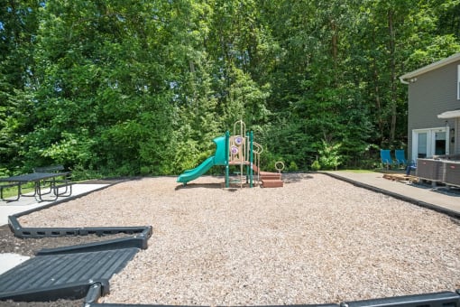 a childrens play area with a playground and a swing set