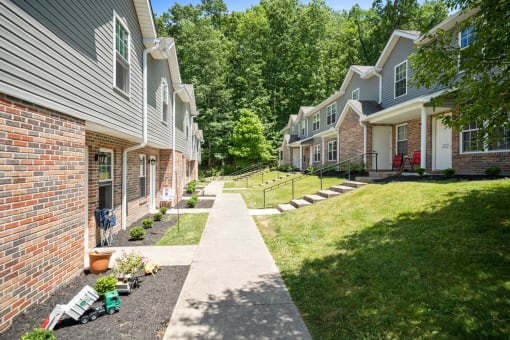 a sidewalk in front of a row of houses