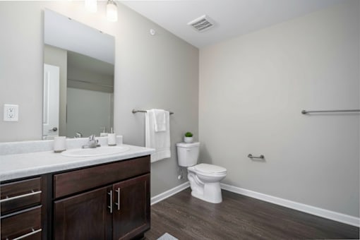 A bathroom with a white toilet and a white sink.