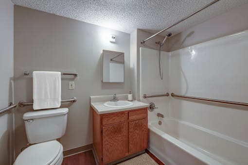 A white toilet sits next to a sink in a small bathroom.