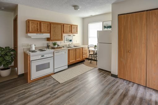 A kitchen with wooden cabinets and a white fridge.