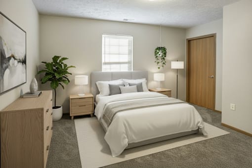 A bedroom with a large bed, nightstands, and a potted plant.