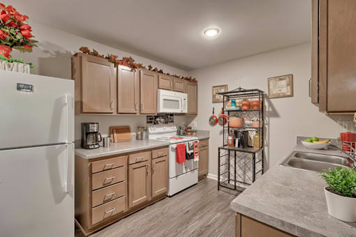 A kitchen with wooden cabinets and a white refrigerator.