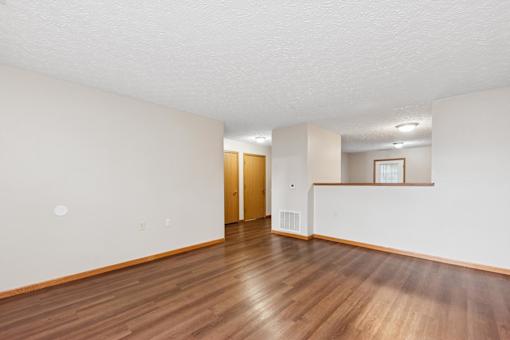 A room with wooden floors and white walls.
