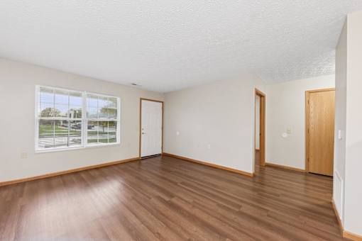 A room with wooden floors and white walls.