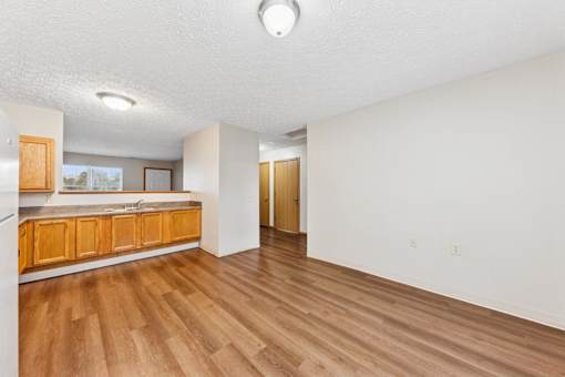 A room with wooden floors and white walls.